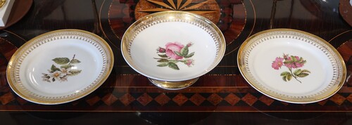 Two plates and a cup with floral decoration